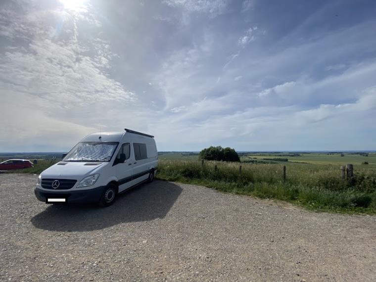 White campervan parked in sunshine