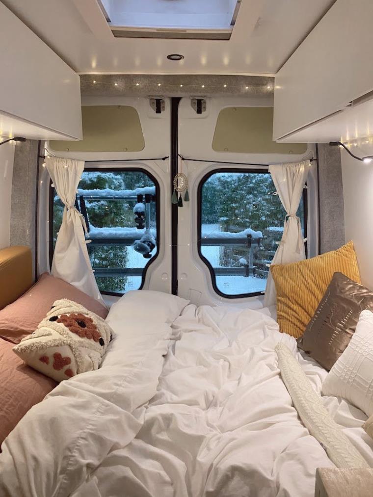 Campervan conversion interior double bed and windows