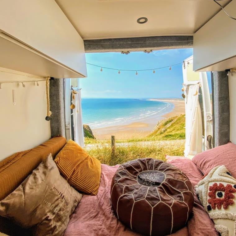 View over huge beach from campervan back doors